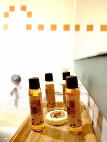 three bottles of honey sitting on a bathroom counter at Herdade da Diabroria - Agroturismo in Beja
