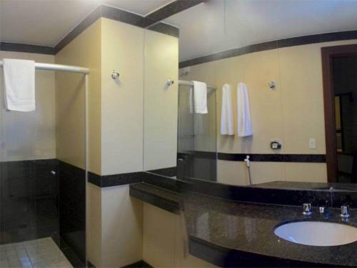 a bathroom with a sink and a mirror at Boulevard Express in Belo Horizonte