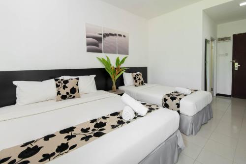 Postel nebo postele na pokoji v ubytování Riverra Inn Langkawi