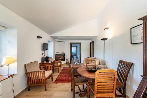 a dining room with a table and chairs at Los Pozos de la Nieve in Constantina