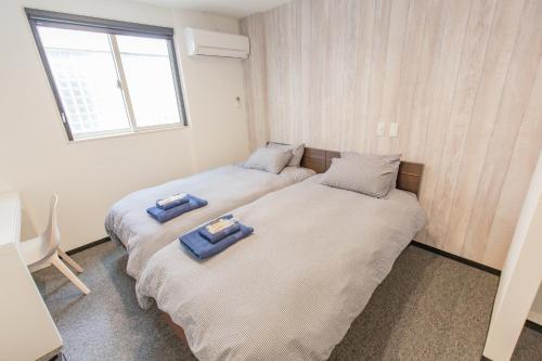 Postel nebo postele na pokoji v ubytování Port House Hatsudai