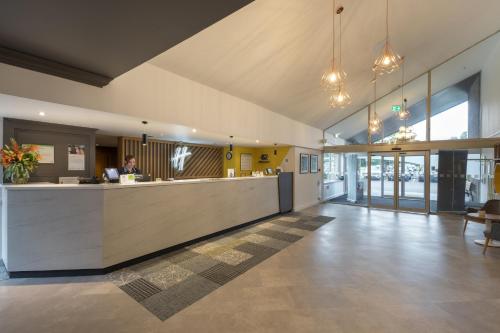 a lobby with a reception counter in a building at Holiday Inn Swindon by IHG in Swindon