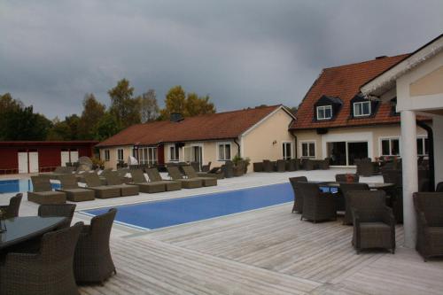 a patio with chairs and a swimming pool at Kosta Lodge in Kosta
