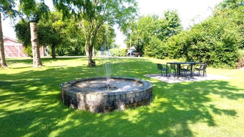 a fire pit in a yard with a table and chairs at Aarhus Hostel og Hotel in Aarhus