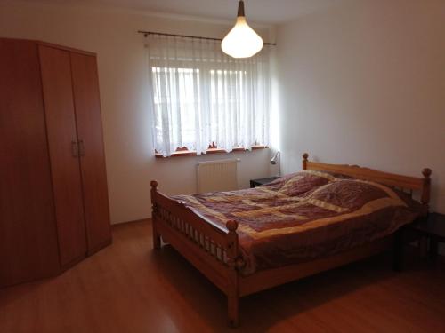 a bedroom with a bed and a window at Apartament Słoneczny in Ustroń