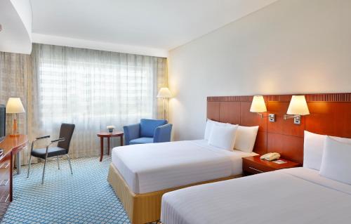 
A bed or beds in a room at Courtyard by Marriott Dubai, Green Community
