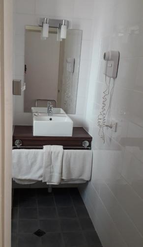 a bathroom with a sink and a mirror at Daydream Motel and Apartments in Broken Hill