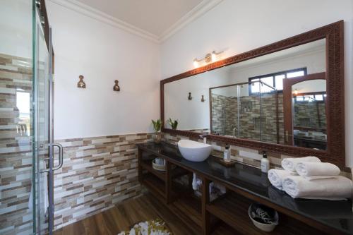 a bathroom with a sink and a mirror at Kena Beach Villas in Marumbi