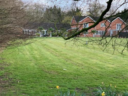 pole trawy z domami w tle w obiekcie Aldercarr Hall w mieście Attleborough
