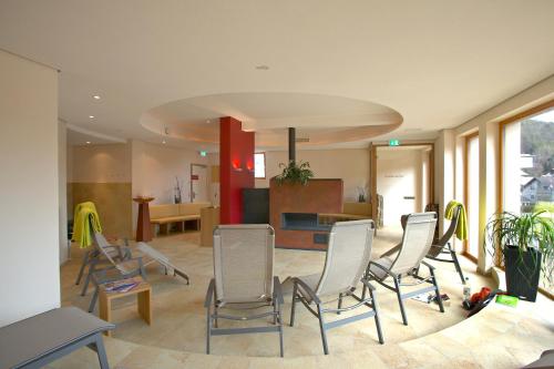 a living room with chairs and a dining room at Landhotel Wilder Mann in Eggingen
