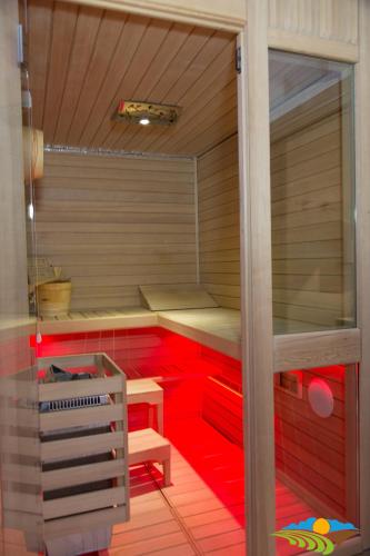 a sauna with red cabinets and a wooden floor at Albergo Diffuso - Il Poggetto tra Urbino & San Marino in Urbino