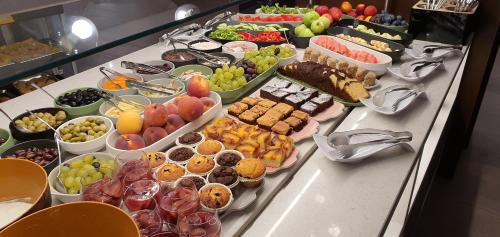 a buffet with many different types of food on a table at Hotel Bulgaria in Burgas City