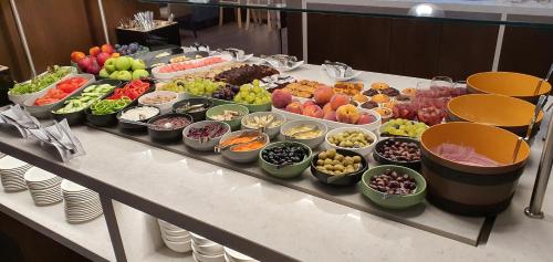 a buffet filled with different types of fruits and vegetables at Hotel Bulgaria in Burgas City