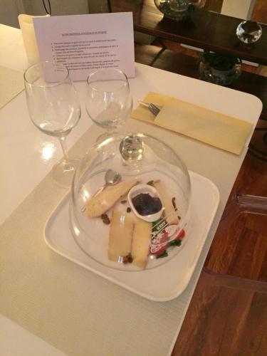 a plate of food on a table with two wine glasses at Hotel Le Griffon in Abidjan