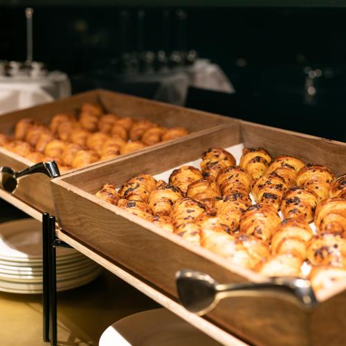 a tray of bagels on a table in aasteryasteryasteryasteryasteryastery at Bianca Maria Palace Hotel in Milan