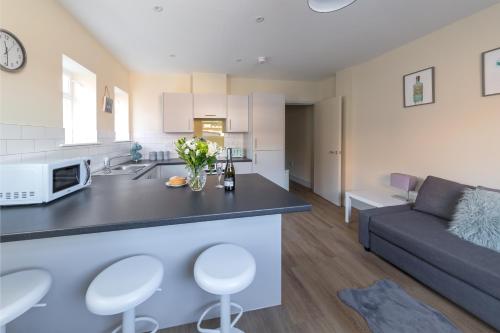 una cucina e un soggiorno con divano e tavolo di Apartment 4, Isabella House, Aparthotel, By RentMyHouse a Hereford