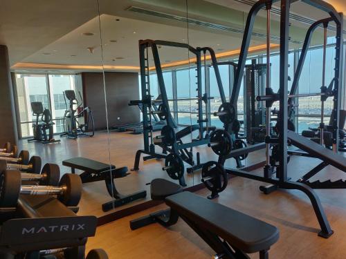 a gym with treadmills and weights in a building at Novotel Dubai Gold District in Dubai