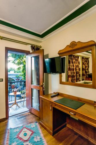 a room with a desk and a mirror at Garden House Hotel - Special Class in Istanbul