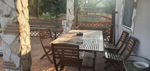 a wooden table and chairs on a patio at B&B La Riserva Nuova in Aprilia