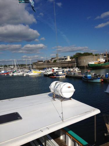 a boat is docked in a harbor with boats at Hotel Du Port in Concarneau