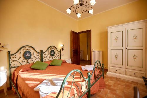 Un dormitorio con una cama con almohadas verdes. en Agriturismo Podere Casa al Vento en Montepulciano