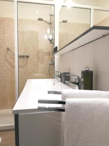a bathroom with a sink and a shower at I Santi Coronati in Syracuse