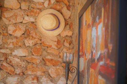 a cowboy hat hanging on a stone wall at Agroturismo Finca Sa Tanca in Cala d´Or