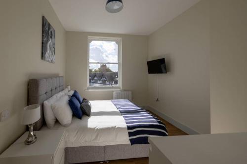 Un dormitorio con una cama grande y una ventana en Apartment 5, Isabella House, Aparthotel, By RentMyHouse, en Hereford