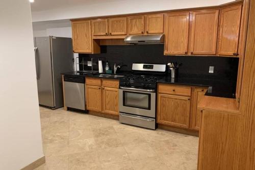 a kitchen with wooden cabinets and stainless steel appliances at Studio flat in the heart of Downtown Chicago in Chicago