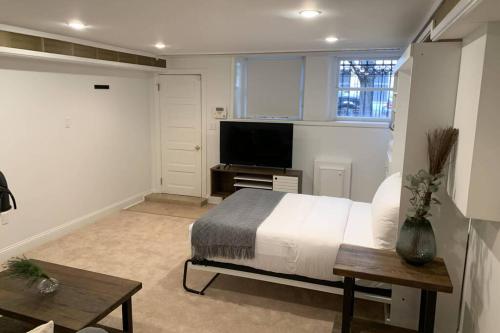 a bedroom with a bed and a flat screen tv at Studio flat in the heart of Downtown Chicago in Chicago