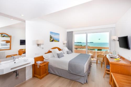 ein Hotelzimmer mit einem Bett und einem Waschbecken sowie einem Bad in der Unterkunft Valentin Reina Paguera - Adults Only in Paguera