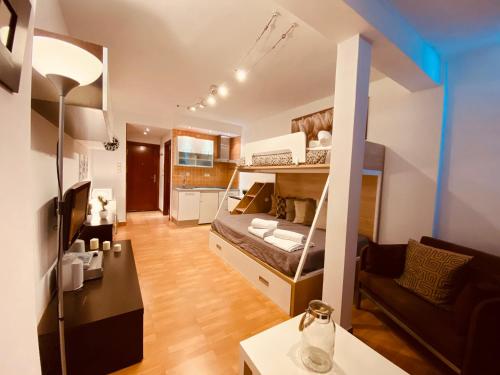 a small apartment with a bed and a living room at Apartamentos Sierra Nevada BlueTTravel - Zona baja in Sierra Nevada