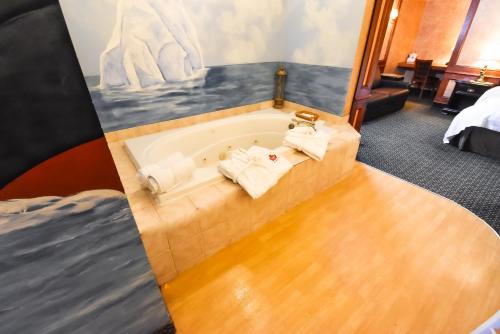 a bathroom with a bath tub with towels in it at Canad Inns Destination Centre Fort Garry in Winnipeg