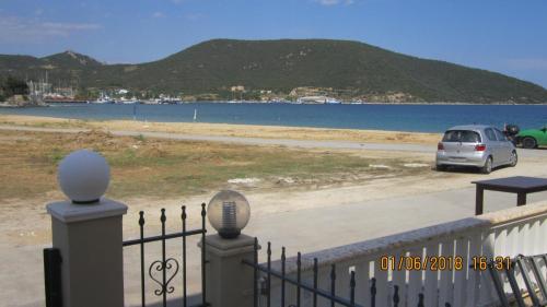 a car parked next to a body of water at Peramos Rent House in Néa Péramos