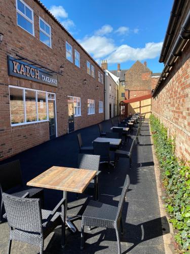 a row of tables and chairs in front of a building at Katch in Northallerton