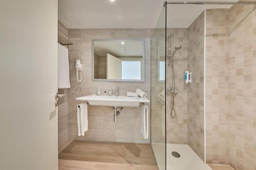 uma casa de banho com um lavatório e um chuveiro em Calanova Sports Residence em Palma de Maiorca