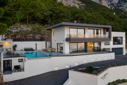 an aerial view of a house with a swimming pool at Villa Melody in Bast