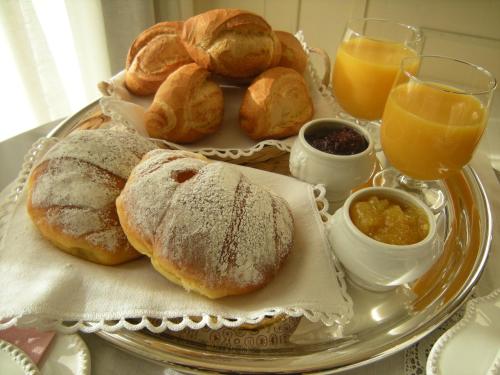 a tray of bread and croissants on a table at Bed & Breakfast Sant'Erasmo in Bergamo