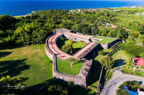 an aerial view of the ruins of a castle with the ocean at Hotel Palmazul - Viña del Mar in Omoa