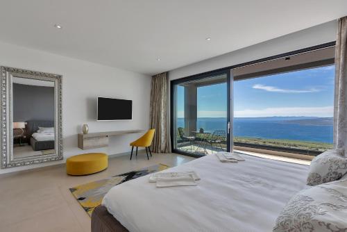 a bedroom with a large bed and a large window at Villa Melody in Bast