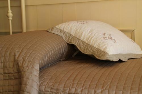 a bed with a pillow on top of it at Bed & Breakfast Sant'Erasmo in Bergamo