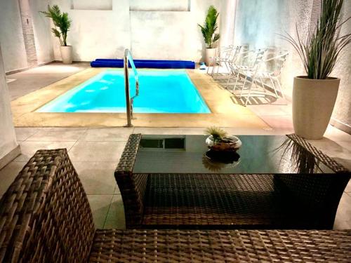 a swimming pool with a water fountain in a room at Hotel Rivadavia in Piriápolis