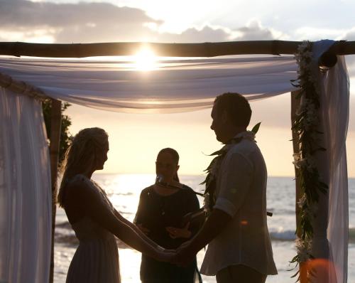 a wedding ceremony on the beach at sunset at Sueño del Mar Beachfront Hotel in Tamarindo