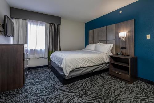 a hotel room with a bed and a television at Candlewood Suites Knoxville Airport-Alcoa, an IHG Hotel in Alcoa