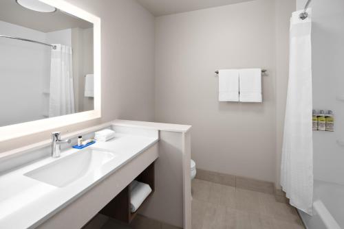 a white bathroom with a sink and a mirror at Holiday Inn Express & Suites - Elkhorn - Lake Geneva Area, an IHG Hotel in Elkhorn