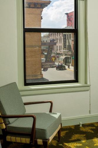 a room with a window with a chair and a view at Finlen Hotel and Motor Inn in Butte