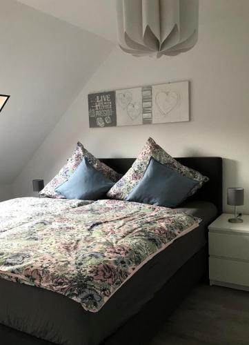 a bedroom with a bed with pillows on it at Altstadtperle Nideggen in Nideggen