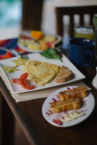 a table with plates of food on a table at Sueño del Mar Beachfront Hotel in Tamarindo