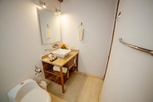 a bathroom with a sink and a toilet at Bioma Boutique Hotel in Mompos