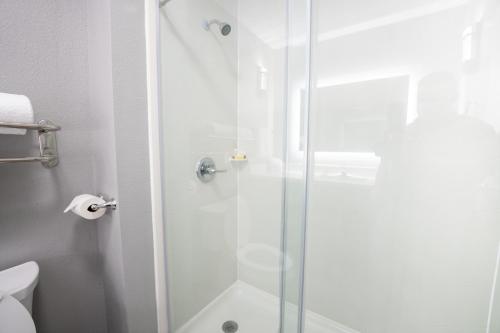 a shower with a glass door in a bathroom at Comfort Suites Seabrook - Kemah in Seabrook